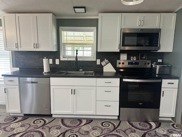 15 Lincoln St, Stonefort, IL 62987 - kitchen with visible vents, dark countertops, freestanding refrigerator, and white cabinetry