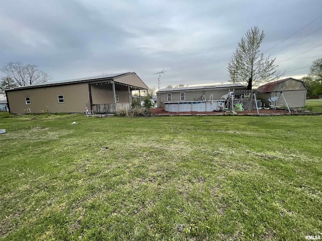 15 Lincoln St, Stonefort, IL 62987 - view of yard featuring an outdoor pool and an outbuilding
