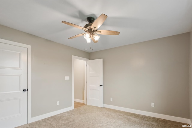 unfurnished bedroom featuring ceiling fan, baseboards, and light colored carpet