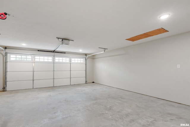 garage featuring a garage door opener and recessed lighting