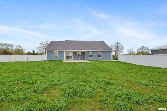back of house with a lawn, a patio area, and a fenced backyard