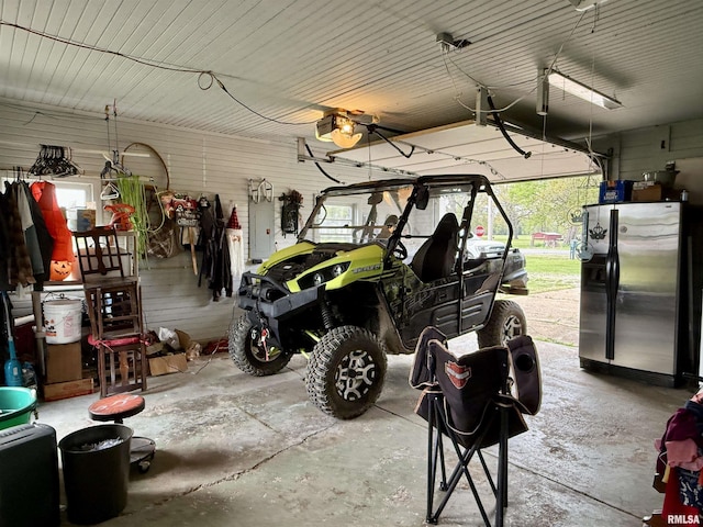 8806 Unionville Rd, Brookport, IL 62910 - garage with a garage door opener, stainless steel refrigerator with ice dispenser, and electric panel