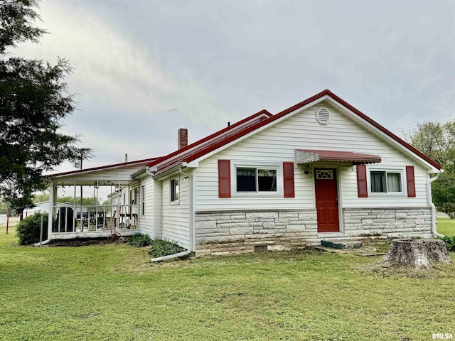 8806 Unionville Rd, Brookport, IL 62910 - view of front of house with a front yard, a chimney, and stone siding