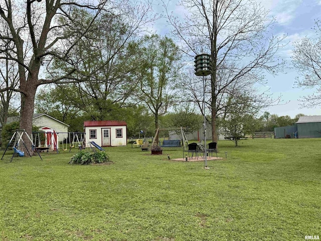 8806 Unionville Rd, Brookport, IL 62910 - view of yard featuring fence, an outbuilding, a playground, and a storage unit