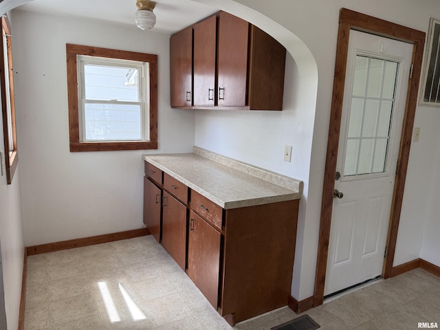 531 N Bush Ave, Hurst, IL 62949 - kitchen featuring visible vents, light countertops, baseboards, and arched walkways