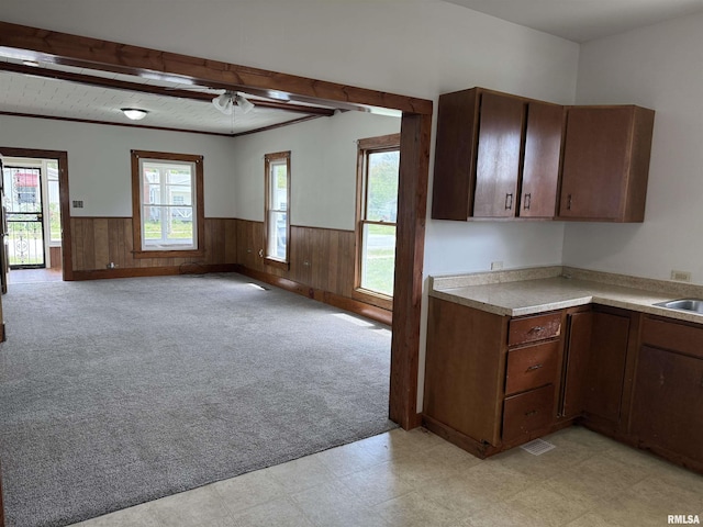 531 N Bush Ave, Hurst, IL 62949 - kitchen featuring wainscoting, beam ceiling, wooden walls, and light countertops