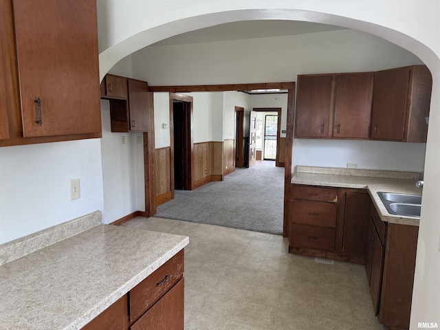 531 N Bush Ave, Hurst, IL 62949 - kitchen featuring light floors, arched walkways, light carpet, and a sink