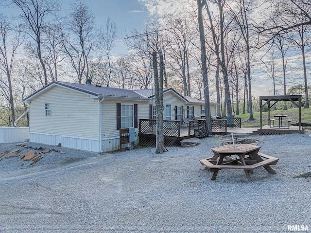 565 Dutton Chapel Rd, Golconda, IL 62938 - exterior space featuring a gazebo, a deck, an outdoor fire pit, and metal roof