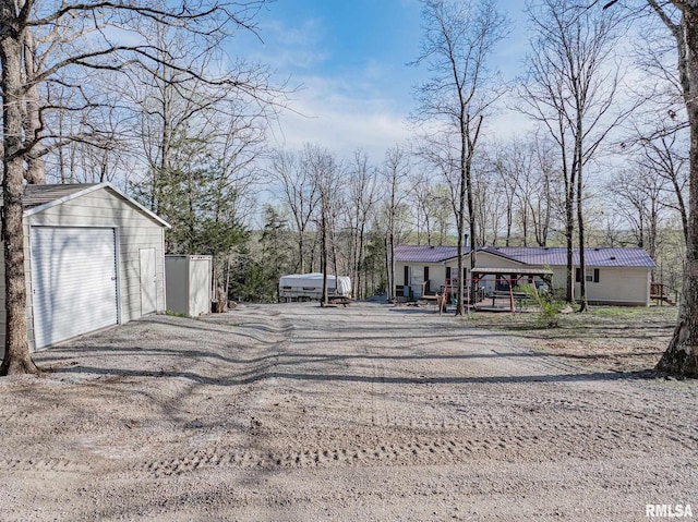 565 Dutton Chapel Rd, Golconda, IL 62938 - view of yard with driveway, an outdoor structure, and a detached garage