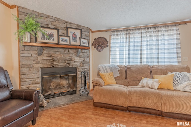 565 Dutton Chapel Rd, Golconda, IL 62938 - living room with a fireplace, wood finished floors, a textured ceiling, and ornamental molding