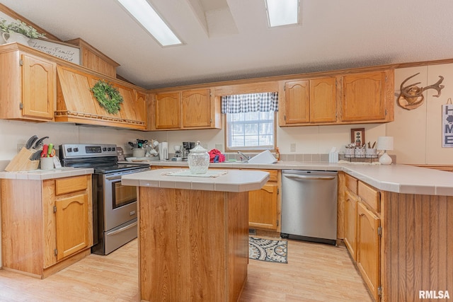 565 Dutton Chapel Rd, Golconda, IL 62938 - kitchen with a center island, tile countertops, light wood-style floors, stainless steel appliances, and lofted ceiling