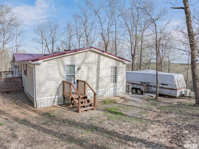 565 Dutton Chapel Rd, Golconda, IL 62938 - rear view of house featuring central AC unit and metal roof