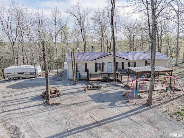 565 Dutton Chapel Rd, Golconda, IL 62938 - view of front of home with playground community, metal roof, and a deck