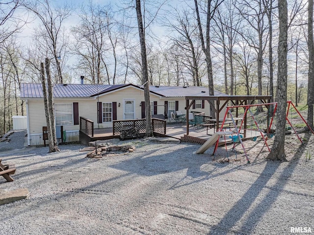 565 Dutton Chapel Rd, Golconda, IL 62938 - back of property featuring a wooden deck and metal roof