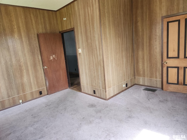 317 N Washington St, Sparta, IL 62286 - empty room featuring carpet, visible vents, and wood walls