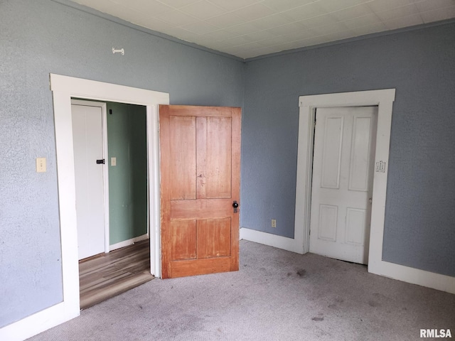 317 N Washington St, Sparta, IL 62286 - unfurnished bedroom featuring baseboards, a textured wall, and carpet flooring