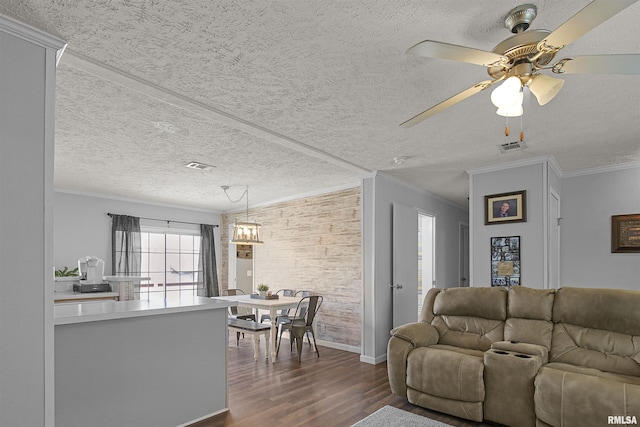 102 E Woolcott St, Harrisburg, IL 62946 - living room with a ceiling fan, dark wood-type flooring, crown molding, baseboards, and a textured ceiling