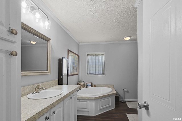102 E Woolcott St, Harrisburg, IL 62946 - full bathroom featuring a bath, a textured ceiling, wood finished floors, vanity, and ornamental molding