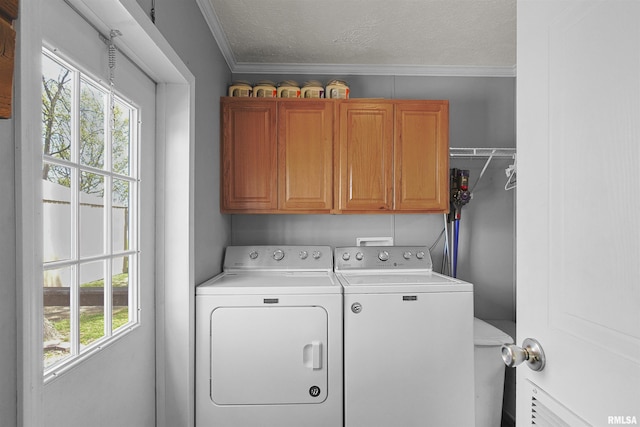 102 E Woolcott St, Harrisburg, IL 62946 - washroom featuring cabinet space, a textured ceiling, ornamental molding, and separate washer and dryer