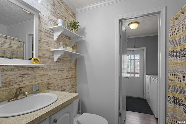 102 E Woolcott St, Harrisburg, IL 62946 - bathroom with wood finished floors, vanity, independent washer and dryer, crown molding, and a textured ceiling