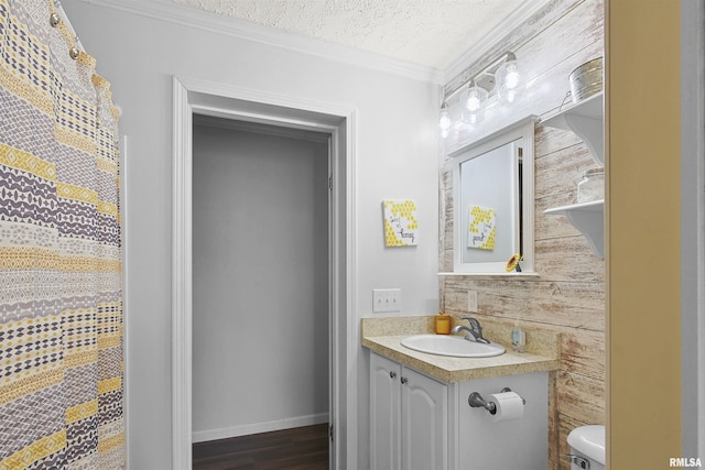 102 E Woolcott St, Harrisburg, IL 62946 - bathroom with a textured ceiling, toilet, wood finished floors, crown molding, and vanity