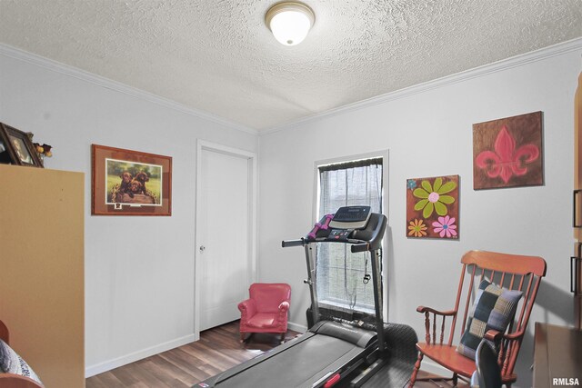 102 E Woolcott St, Harrisburg, IL 62946 - exercise area with wood finished floors, a textured ceiling, baseboards, and ornamental molding