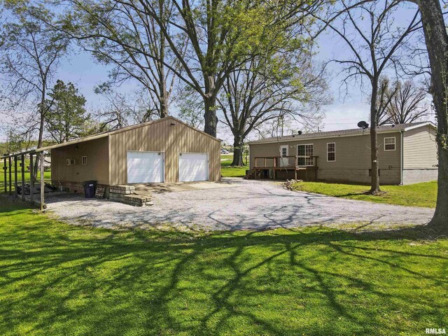 102 E Woolcott St, Harrisburg, IL 62946 - exterior space featuring an outdoor structure, a deck, and a detached garage