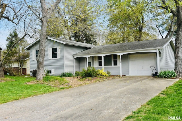 1001 S Emerald Ln, Carbondale, IL 62901 - split level home with an attached garage, driveway, a porch, and a front yard