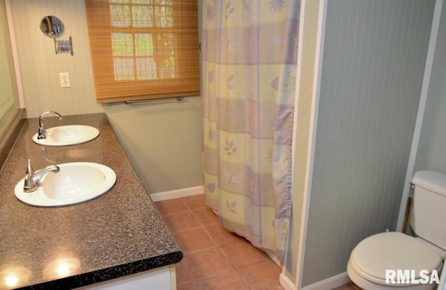 1001 S Emerald Ln, Carbondale, IL 62901 - full bathroom with double vanity, tile patterned flooring, toilet, and a sink