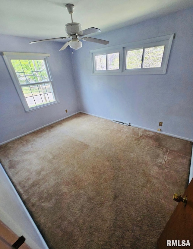 1001 S Emerald Ln, Carbondale, IL 62901 - carpeted empty room featuring visible vents, baseboards, and ceiling fan