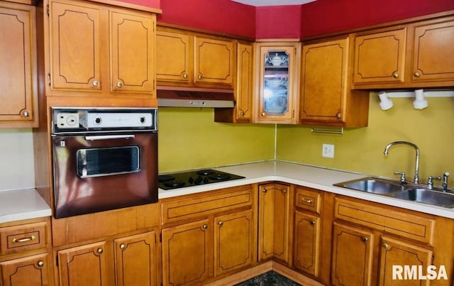 1001 S Emerald Ln, Carbondale, IL 62901 - kitchen with oven, a sink, extractor fan, brown cabinetry, and black electric stovetop