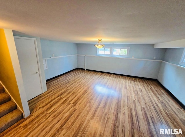 1001 S Emerald Ln, Carbondale, IL 62901 - spare room featuring baseboards, wood finished floors, and stairs