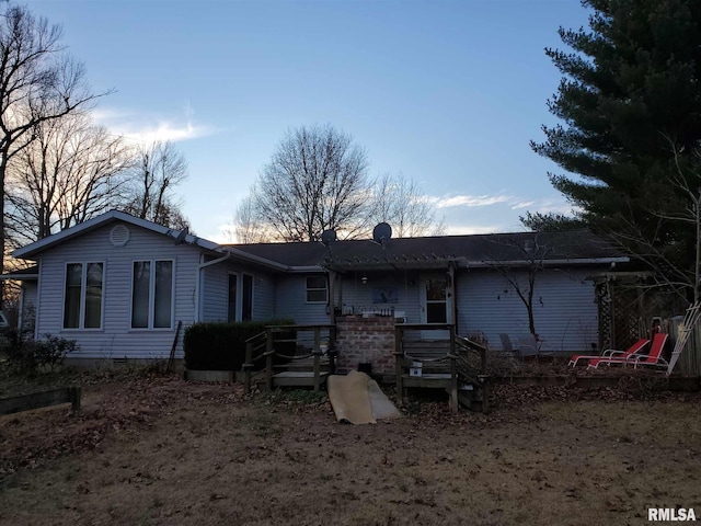 rear view of house featuring a deck