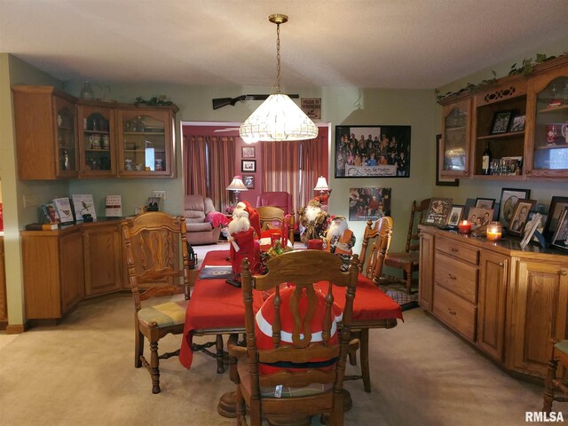 living area featuring carpet and ceiling fan