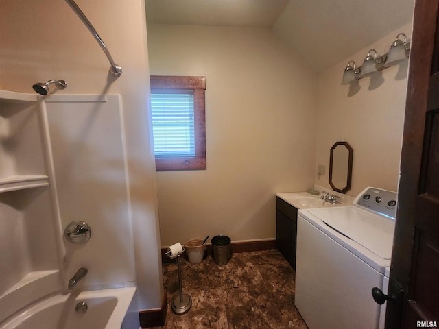 interior space featuring baseboards, a sink, laundry area, and washer / clothes dryer