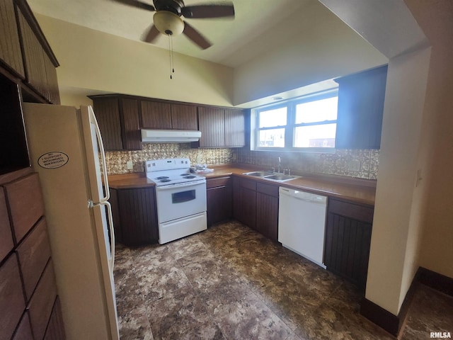 kitchen featuring under cabinet range hood, white appliances, a sink, and tasteful backsplash