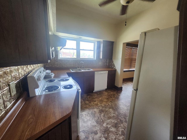 kitchen featuring a sink, decorative backsplash, white appliances, ceiling fan, and stone finish flooring