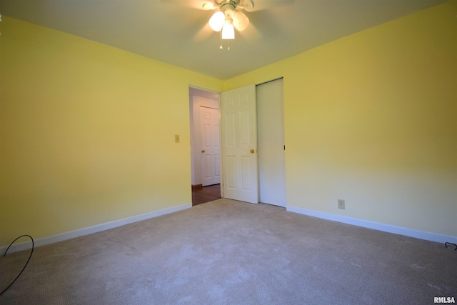 unfurnished bedroom with carpet flooring, baseboards, and a ceiling fan