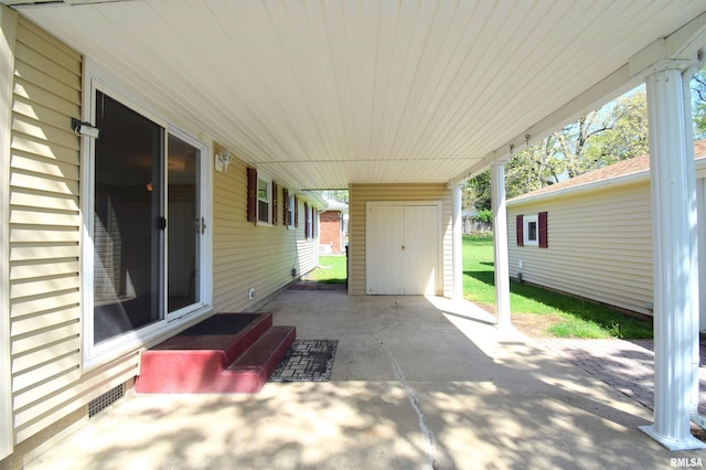 view of patio with an outdoor structure and visible vents