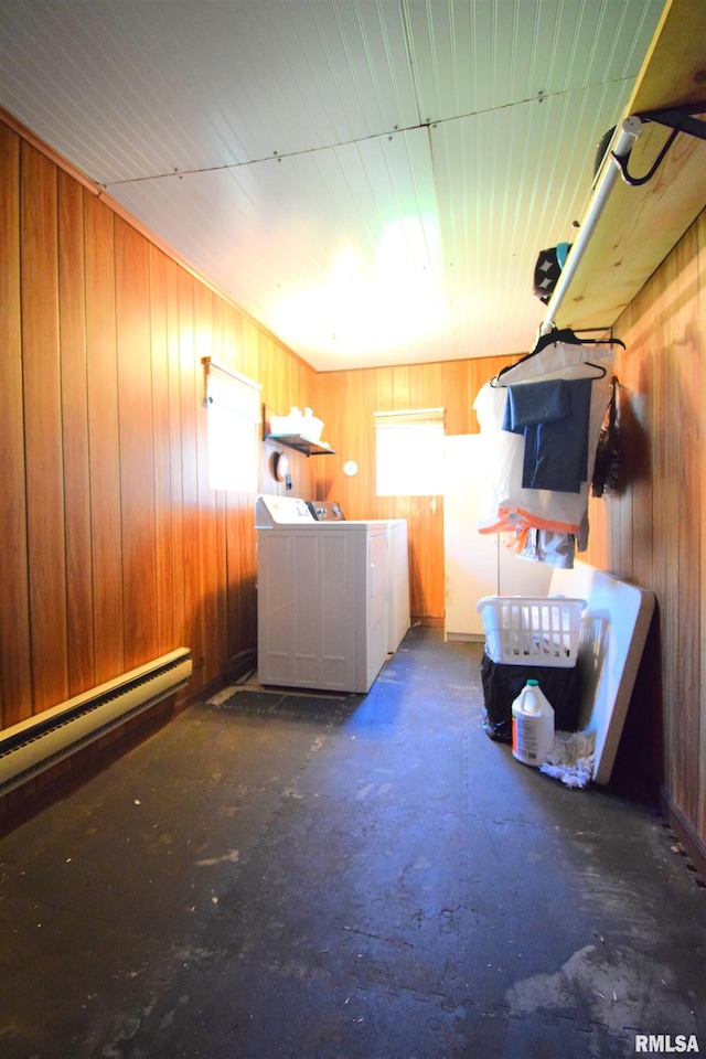 laundry area with a baseboard heating unit, wooden walls, and laundry area