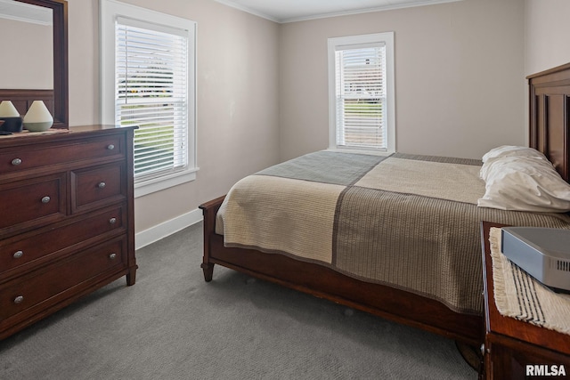 bedroom with carpet floors, crown molding, baseboards, and multiple windows