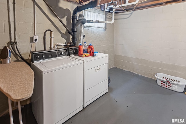 washroom with washing machine and clothes dryer and laundry area