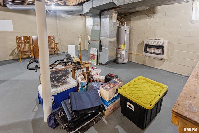 unfinished below grade area featuring water heater, concrete block wall, and heating unit