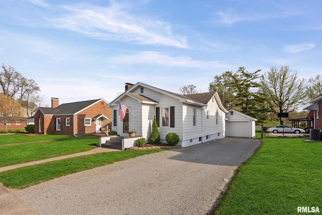view of front of home featuring a detached garage, an outbuilding, a chimney, and a front lawn