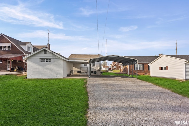 view of front of property with a chimney, a front lawn, driveway, and a carport