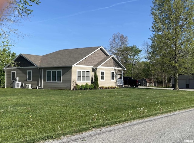 view of front of home featuring central air condition unit and a front yard