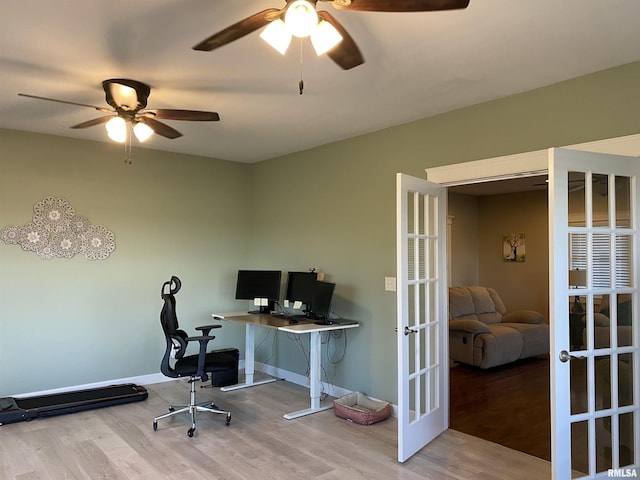 office area featuring wood finished floors, a ceiling fan, baseboards, and french doors