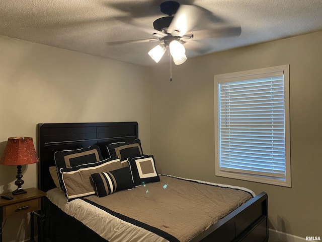 bedroom featuring a ceiling fan and a textured ceiling