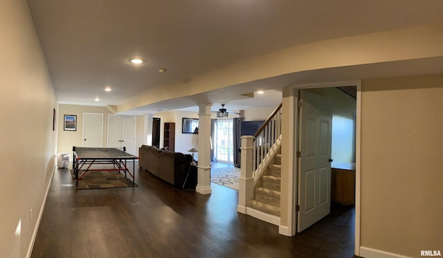 rec room featuring recessed lighting, baseboards, dark wood-type flooring, and decorative columns
