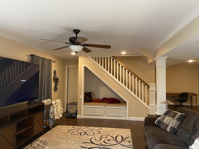 living room with dark wood finished floors, stairway, a ceiling fan, and decorative columns